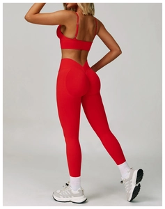 Detail of red V-waist yoga leggings and sports bra with seamless lifting effect