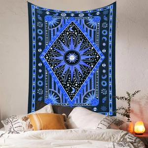 Close-up of Bohemian sun and moon tapestry hanging on a bedroom wall as decoration