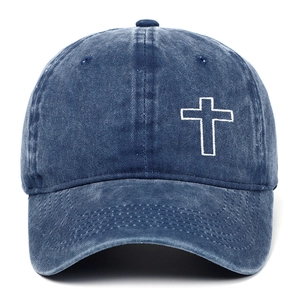 Close-up of white cross embroidery on distressed washed cotton navy baseball cap