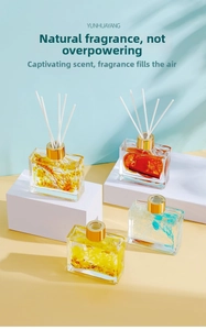 Detail of four transparent glass diffusers with colorful dried flowers and gold caps