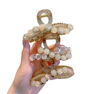 Elegant champagne hair claw clips with pearls and camellia flowers for thick hair