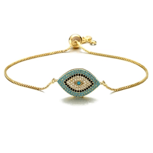 Adjustable golden evil eye bracelet featuring blue and white micro-pave cubic zirconia stones