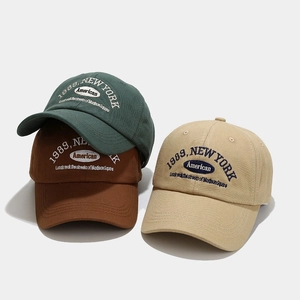 Three 1989 embroidered cotton baseball caps in dark green, brown, and beige colors