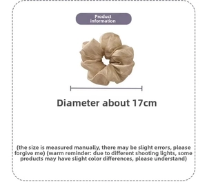 Detail view of large champagne gold silk scrunchie with 17cm diameter measurement