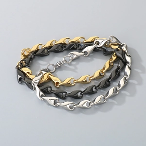 Detailed view of rhoboid link bracelets in gold, black, and silver finishes with lobster clasp