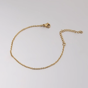 Close-up of 1.5mm gold stainless steel cross chain with lobster clasp and extender