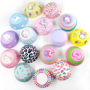 Macro view of patterned paper muffin cups with various colorful cartoon and geometric designs