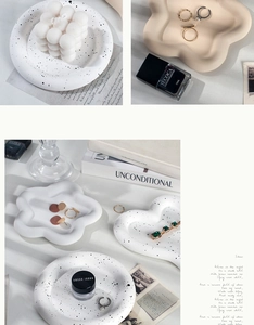 Macro detail of heart and flower jewelry display tray with modern ink splatter finish