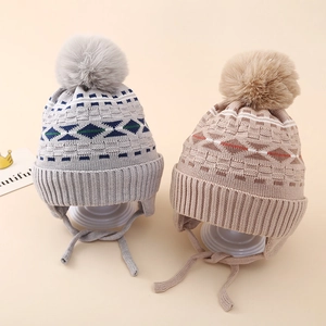 Fleece-lined knit winter hat for boys with jacquard diamond pattern and faux fur pompom