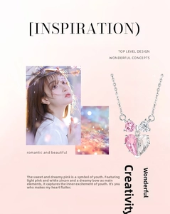 Macro detail of 925 silver heart necklace with pink zircon stone and bow pendant design