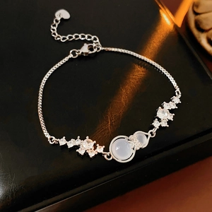 Macro shot of silver gourd bracelet with sparkling zircons on dark leather backdrop