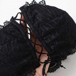 Detailed view of a black lace strapless bra featuring an elegant front lace-up tie design