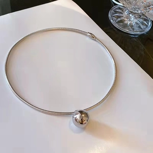 Minimalist silver spherical pendant necklace on a sleek snake chain over white background