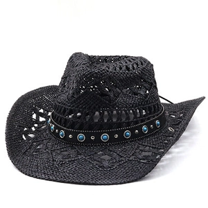 Close-up of black straw cowboy hat featuring hollow weave, turquoise beads and metal studs