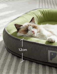 Detail view of pet bed showing 12cm height, brown corduroy fabric and green plush interior