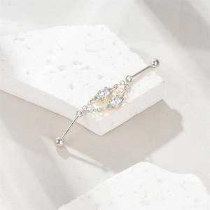 Detail of s925 silver industrial piercing bar with double zircons and fine chain link