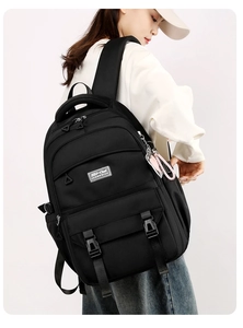 Side view of black large capacity casual backpack showing ergonomic straps and buckle detail