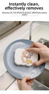 Kitchen dishwashing wood pulp sponge creating rich foam on a plate in kitchen sink