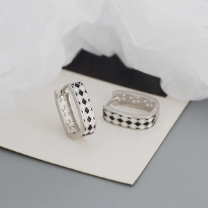 Detail view of S925 silver U-shaped checkered earrings with clover cutout patterns