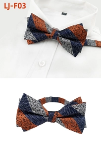 Macro detail of navy blue and orange diagonal striped bowtie on white shirt collar