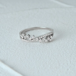 Detailed macro shot of silver S925 crown-shaped ring with luxury diamond settings