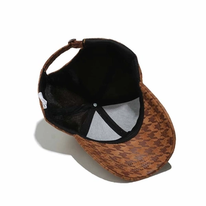 Detail view of brown houndstooth baseball cap interior with mesh lining and adjustable strap