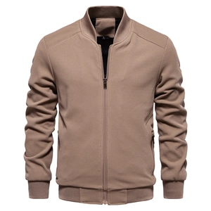 Detail of khaki bomber jacket with waffle texture fabric and metal zipper pockets