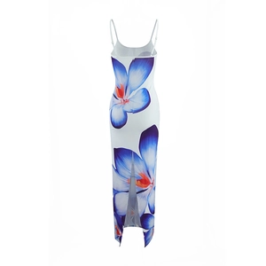 Detail view of back slit on a white maxi dress with blue floral print and slim straps