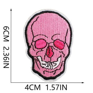 Detailed view of pink skull embroidery patch with size measurements 6cm by 4cm