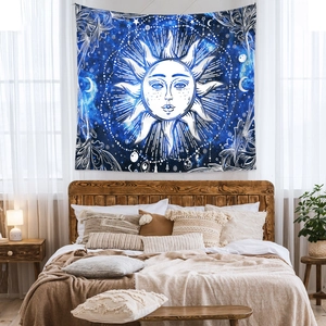 Detailed texture of bohemian star and sun tapestry hanging over a cozy bedroom bed