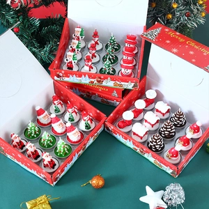 Close-up of a 12-piece Christmas tea light candle set with Santa and snowman shapes