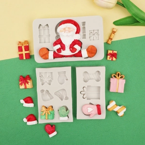 Macro detail of white silicone Christmas molds featuring Santa, gift boxes, and bow shapes