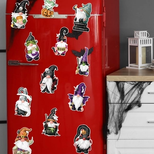 Detail of 11 Halloween gnome skeletons magnets displayed on a red refrigerator surface