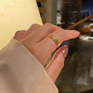 Close-up of a vintage 18k gold plated titanium steel adjustable open ring with bead texture