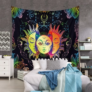 Detail of bohemian mandala tapestry with sun and moon faces on bedroom wall