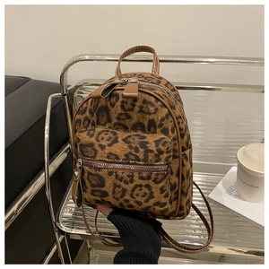Detail of vintage leopard print mini backpack with leather handle and zipper compartments