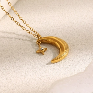Detailed view of 18K gold plated moon and star pendant necklace with sparkling zircon