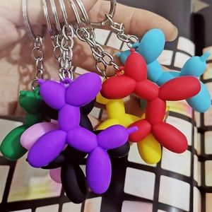 Colorful silicone balloon dog keychains with silver metal rings shown in multiple vibrant colors
