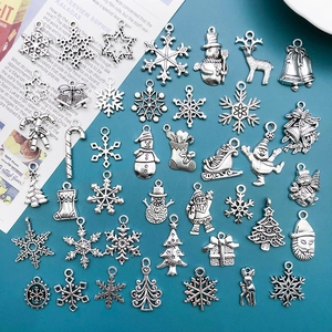 Detailed collection of vintage silver alloy Christmas charms including snowflakes and trees