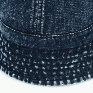 Close-up of vintage denim bucket hat showing washed fabric texture and stitched details