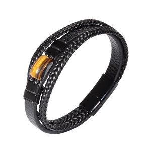 Macro view of multi-layer leather bracelet with tiger eye stone and magnetic clasp