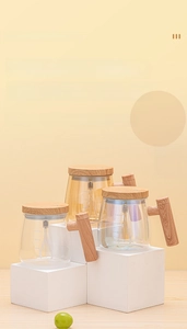 Detailed view of automatic mixing cups in clear, amber, and iridescent glass with wood handles