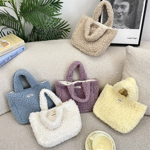 Plush lamb wool tote bags in five colors arranged on a cozy sofa for daily use