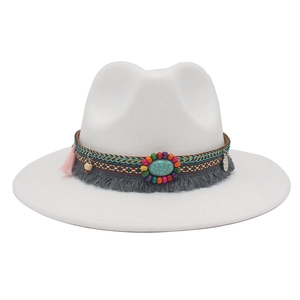Detail of bohemian white cowboy hat band with turquoise stone, tassels and beads