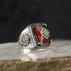 Macro shot of vintage silver and gold ring featuring a rectangular red gemstone inlay