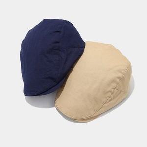 Close-up of quick-dry navy and khaki ivy caps showing twill texture and stitching
