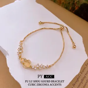 Adjustable gold zircon bracelet with hulu gourd charm and cat eye stone on stone stand