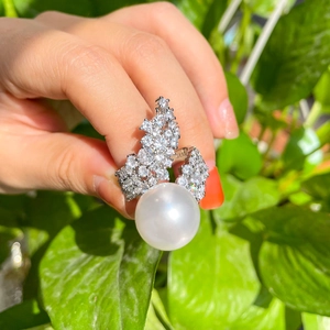 French luxury white pearl and cubic zirconia open ring shown on hand in natural light