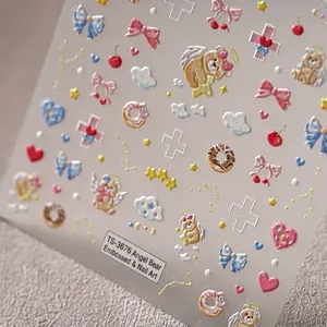 5D embossed angel bear nail stickers with bows and donuts on a textured background