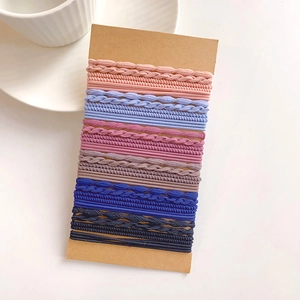Detailed view of colorful braided elastic hair ties set on a craft card organizer